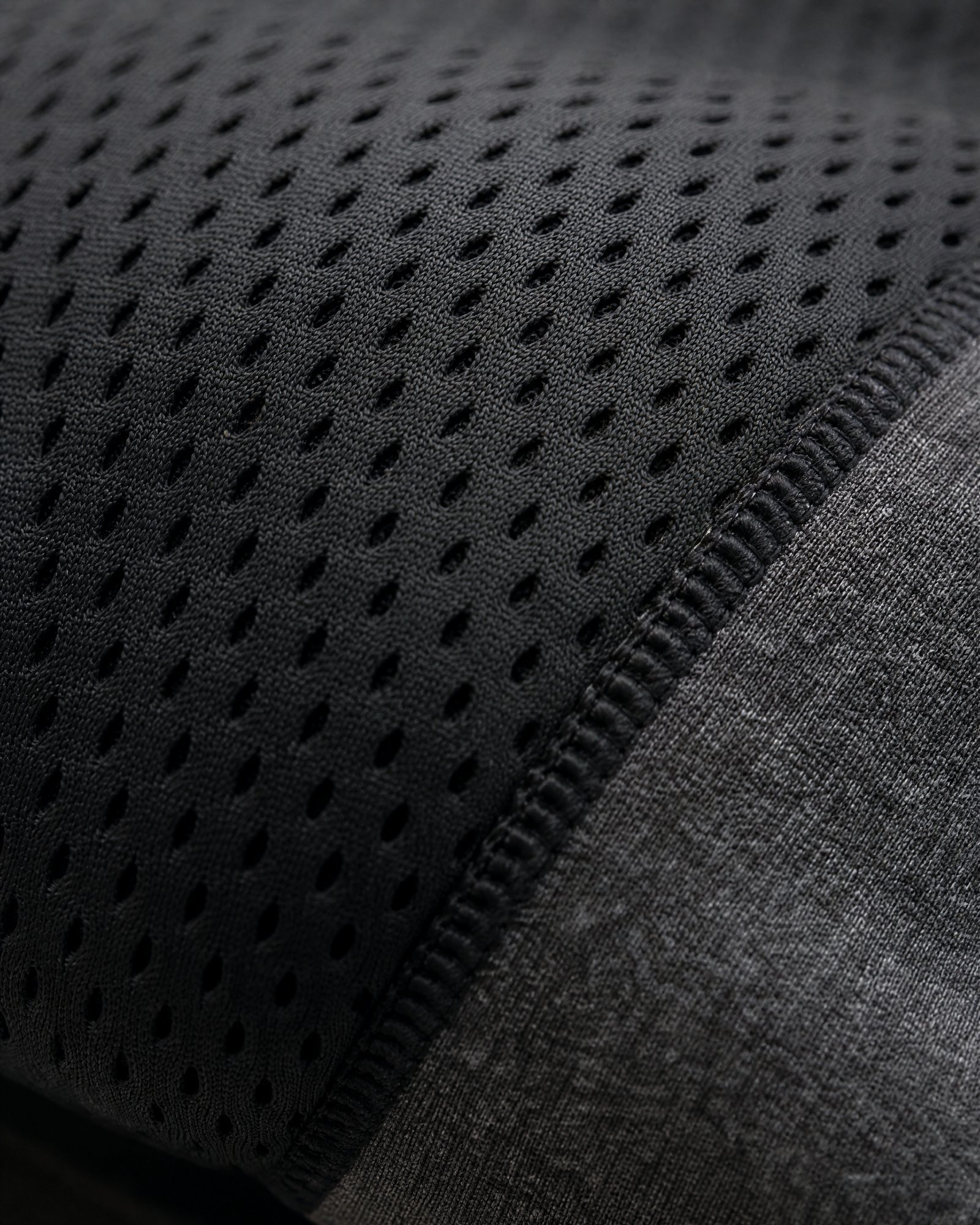 Macro of the black mesh knit over the padded edge of the Pillow Cool