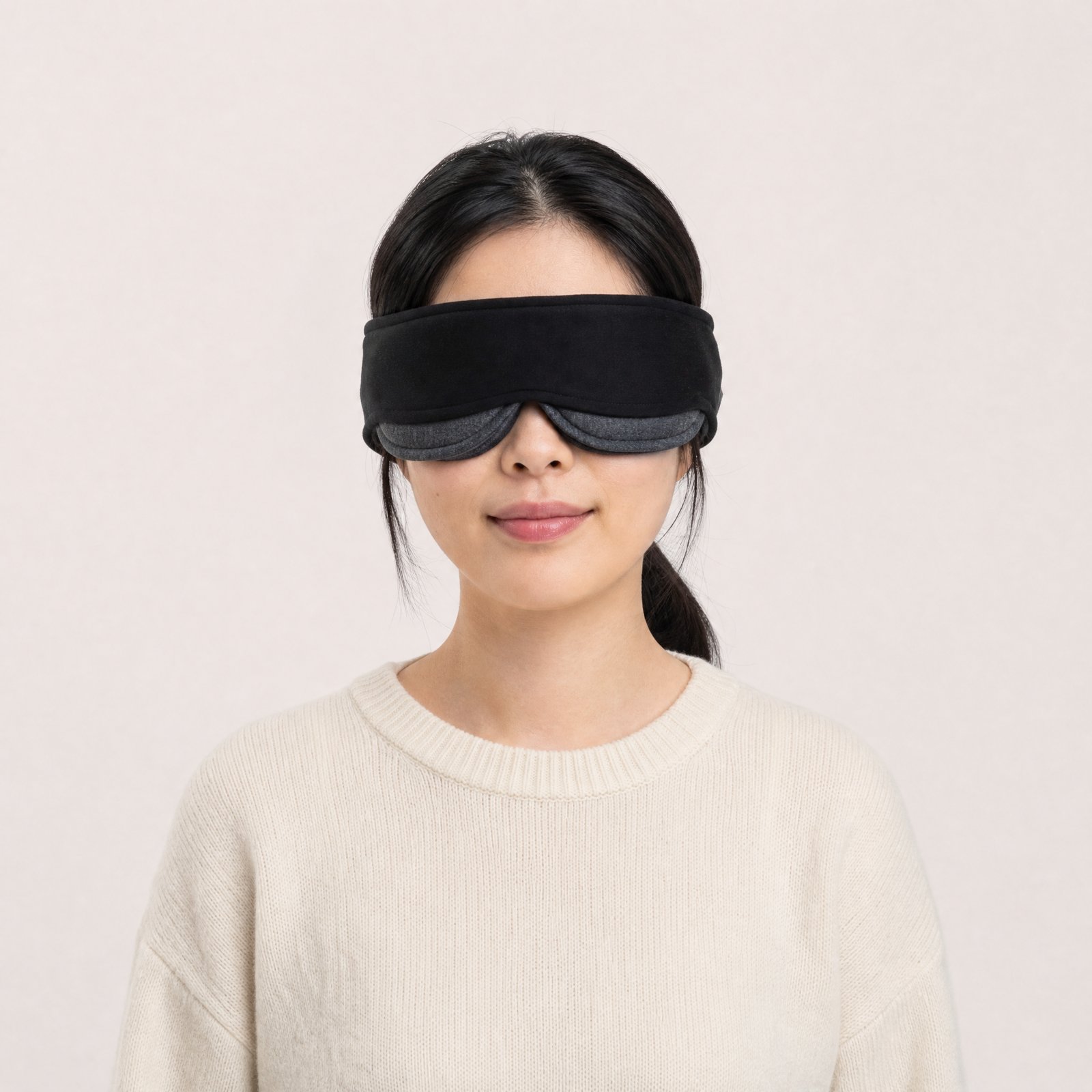 A woman wearing the black NODD sleep mask